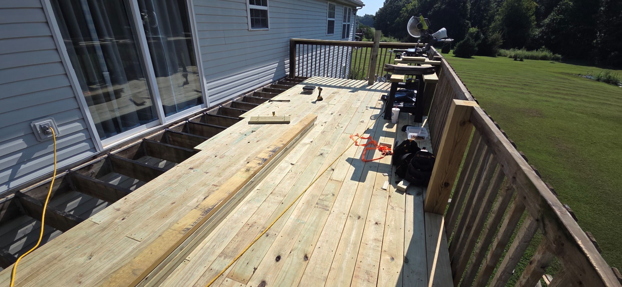 Another view of deck repairs in progress with new boards and exposed framing