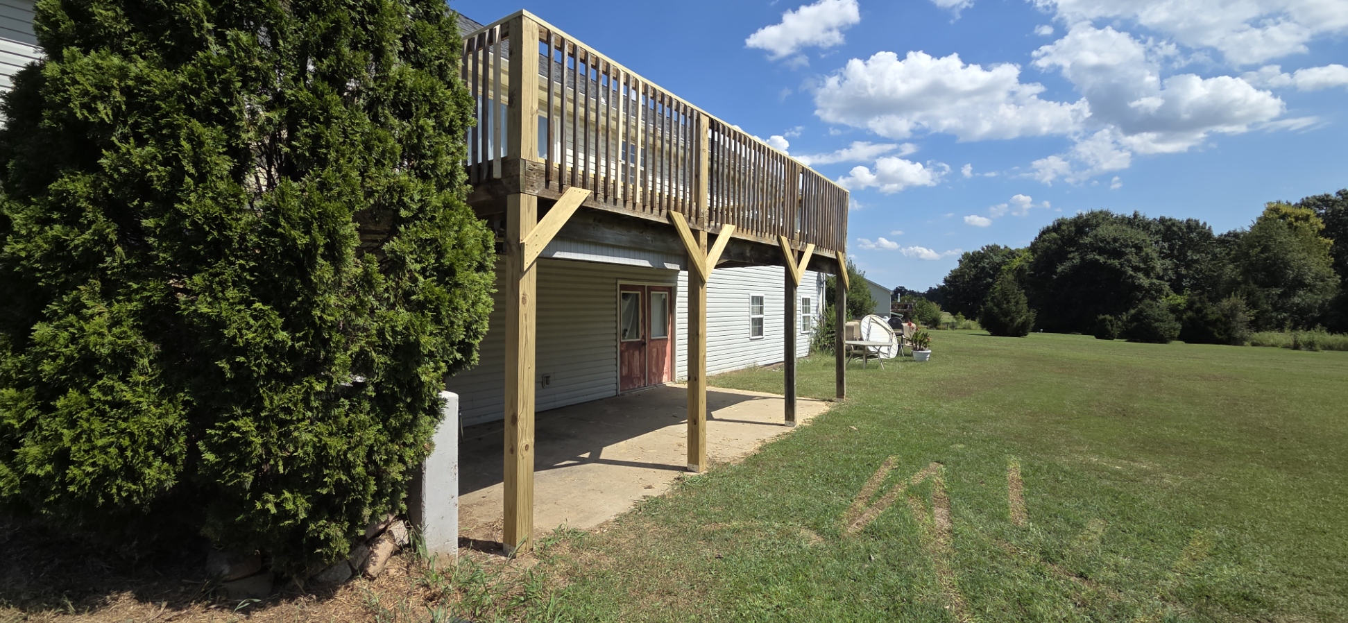 Side view of the repaired elevated deck with updated posts and diagonal bracing