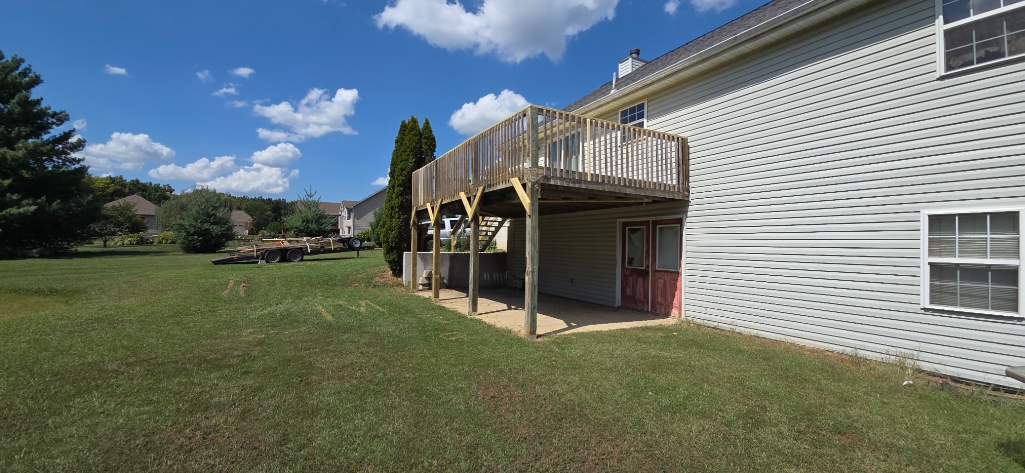 Elevated deck after repairs, showing updated wood posts, bracing, and rail details